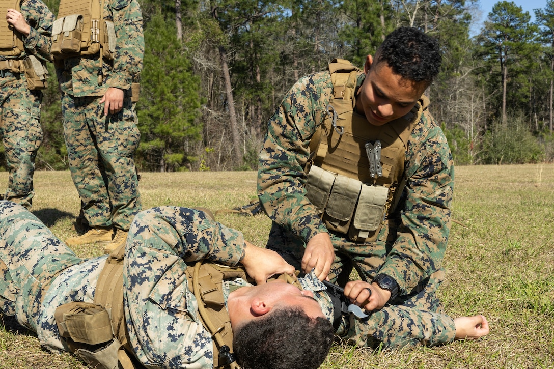 U.S. Marine Corps Lance Cpl. O’Brian Ortiz, a financial management resource analyst with Marine Forces Reserve, applies a tourniquet to a simulated casualty during a field exercise on Camp Shelby Joint Forces Training Center, Mississippi, March 10, 2025. MARFORRES Marines conducted the exercise to maintain proficiency in warfighting, communication and leadership skills common to all Marines. (U.S. Marine Corps photo by Lance Cpl. Van Hoang)