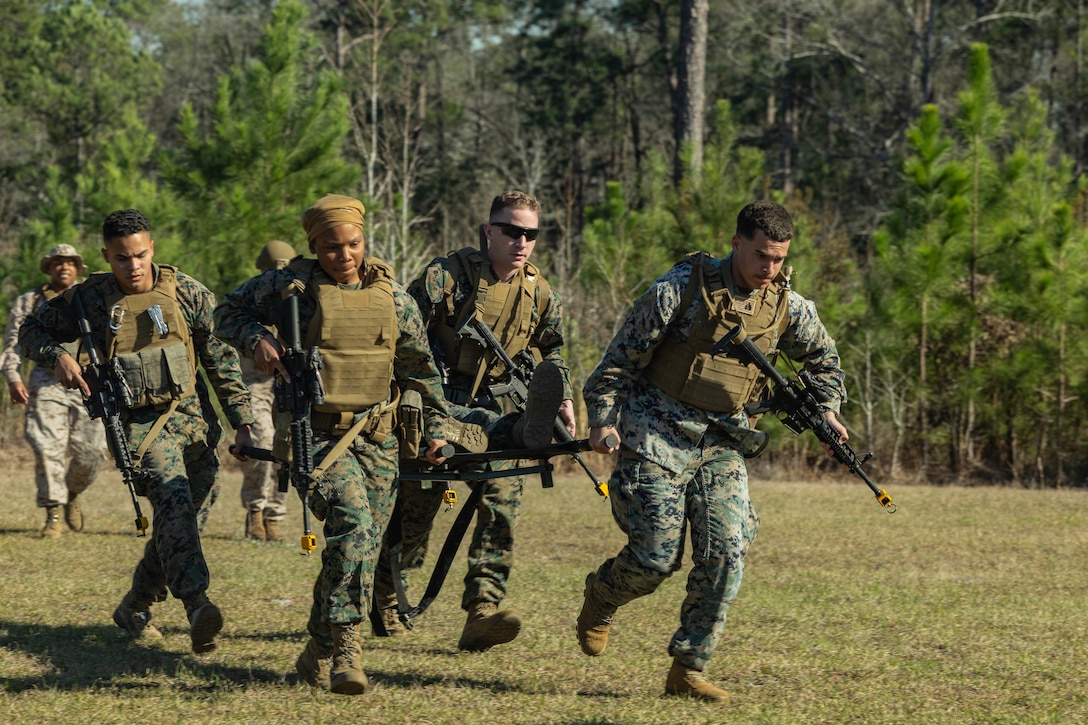 U.S. Marines with Marine Forces Reserve use a stretcher to transport a simulated casualty to a casualty collection point during a field exercise on Camp Shelby Joint Forces Training Center, Mississippi, March 10, 2025. MARFORRES Marines conducted the exercise to maintain proficiency in warfighting, communication and leadership skills common to all Marines. (U.S. Marine Corps photo by Lance Cpl. Van Hoang)