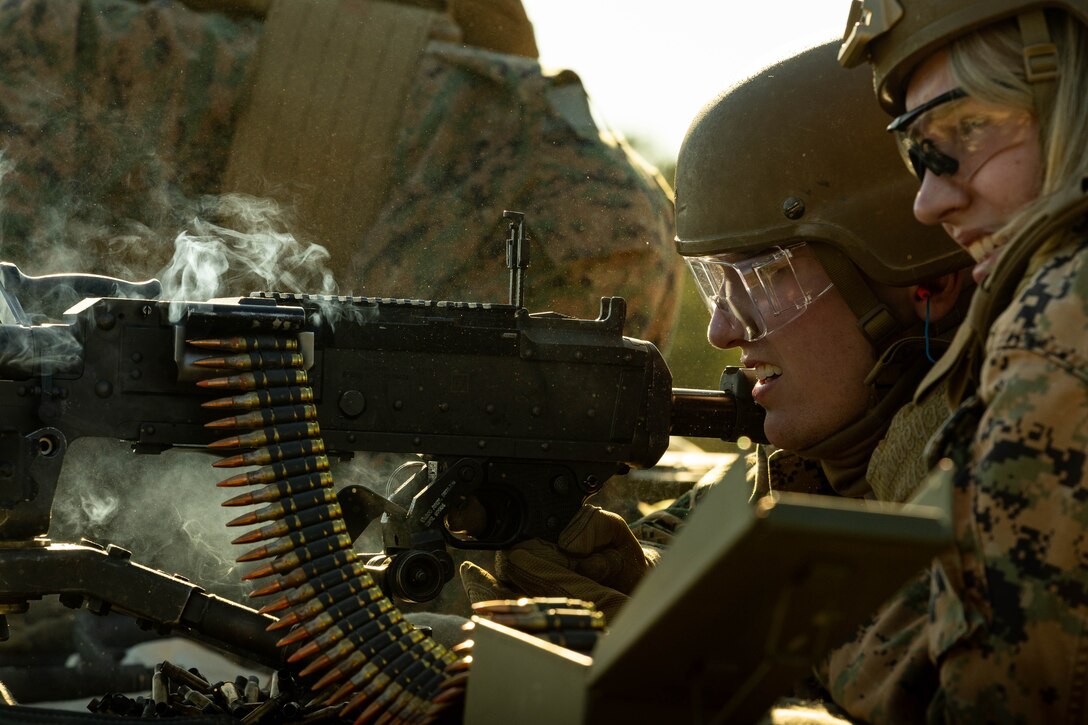 U.S. Marine Corps Lance Cpl. Carson Davis, left, Marine air-ground task force planner, and Sgt. Sidney Mattila, staff judge advocate, Marine Forces Reserve, fire an M240B machine gun during a field exercise on Camp Shelby Joint Forces Training Center, Mississippi, March 11, 2025. MARFORRES Marines conducted the exercise to maintain proficiency in warfighting, communication and leadership skills common to all Marines. (U.S. Marine Corps photo by Lance Cpl. Van Hoang)