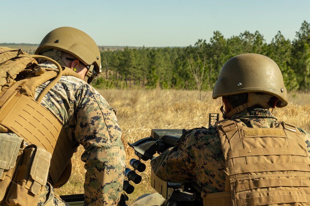 U.S. Marine Corps Sgt. Kaleb Michael, left, supply clerk, and Cpl. Armando Flores, legal service specialist, Marine Forces Reserve fires a Mark 19 grenade launcher during a field exercise on Camp Shelby Joint Forces Training Center, Mississippi, March 11, 2025. MARFORRES Marines conducted the exercise to maintain proficiency in warfighting, communication and leadership skills common to all Marines. (U.S. Marine Corps photo by Lance Cpl. Van Hoang)