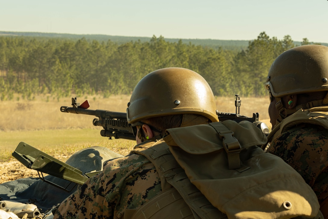 U.S. Marine Corps Sgt. Austin Trausch, left, a network administrator with 4th Marine Division, and Pfc. Demeko Croft, a maintenance management specialist with Marine Forces Reserve, fire an M240B machine gun during a field exercise on Camp Shelby Joint Forces Training Center, Mississippi, March 11, 2025. MARFORRES Marines conducted the exercise to maintain proficiency in warfighting, communication and leadership skills common to all Marines. (U.S. Marine Corps photo by Lance Cpl. Van Hoang)
