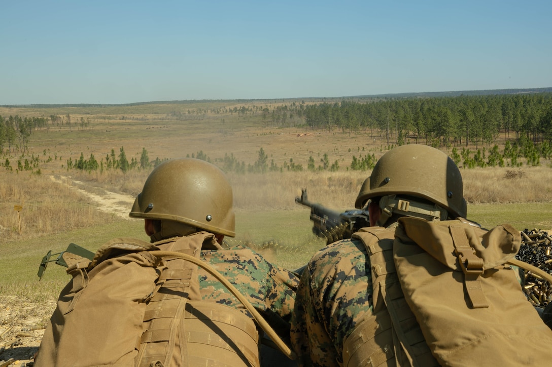 U.S. Marine Corps Sgt. Reeves Alexander, left, career planner, and Cpl. Juan Ramirez, supply clerk, Marine Forces Reserve fire M240B machine guns during a field exercise on Camp Shelby Joint Forces Training Center, Mississippi, March 11, 2025. MARFORRES Marines conducted the exercise to maintain proficiency in warfighting, communication and leadership skills common to all Marines. (U.S. Marine Corps photo by Lance Cpl. Van Hoang)