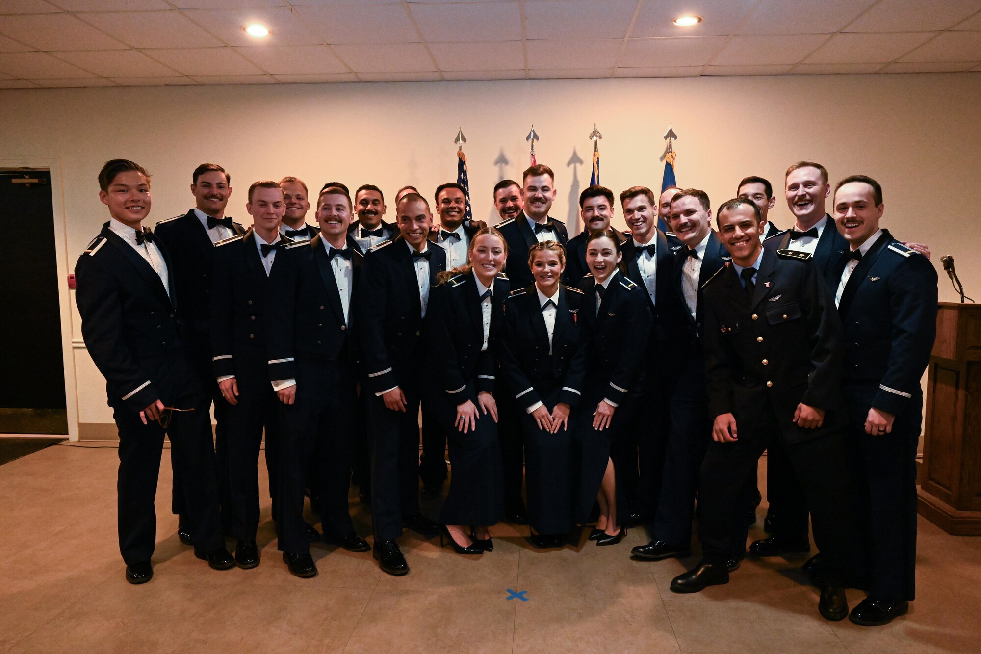 The graduating class of 25-07 pose together for a group photo at Laughlin Air Force Base, Texas, March. 20, 2025. Twenty-three U.S. Air Force officers were awarded silver wings during the ceremony, symbolizing their completion of the Undergraduate Pilot Training program. (U.S. Air Force photo by Airman 1st Class Harrison Sullivan)
