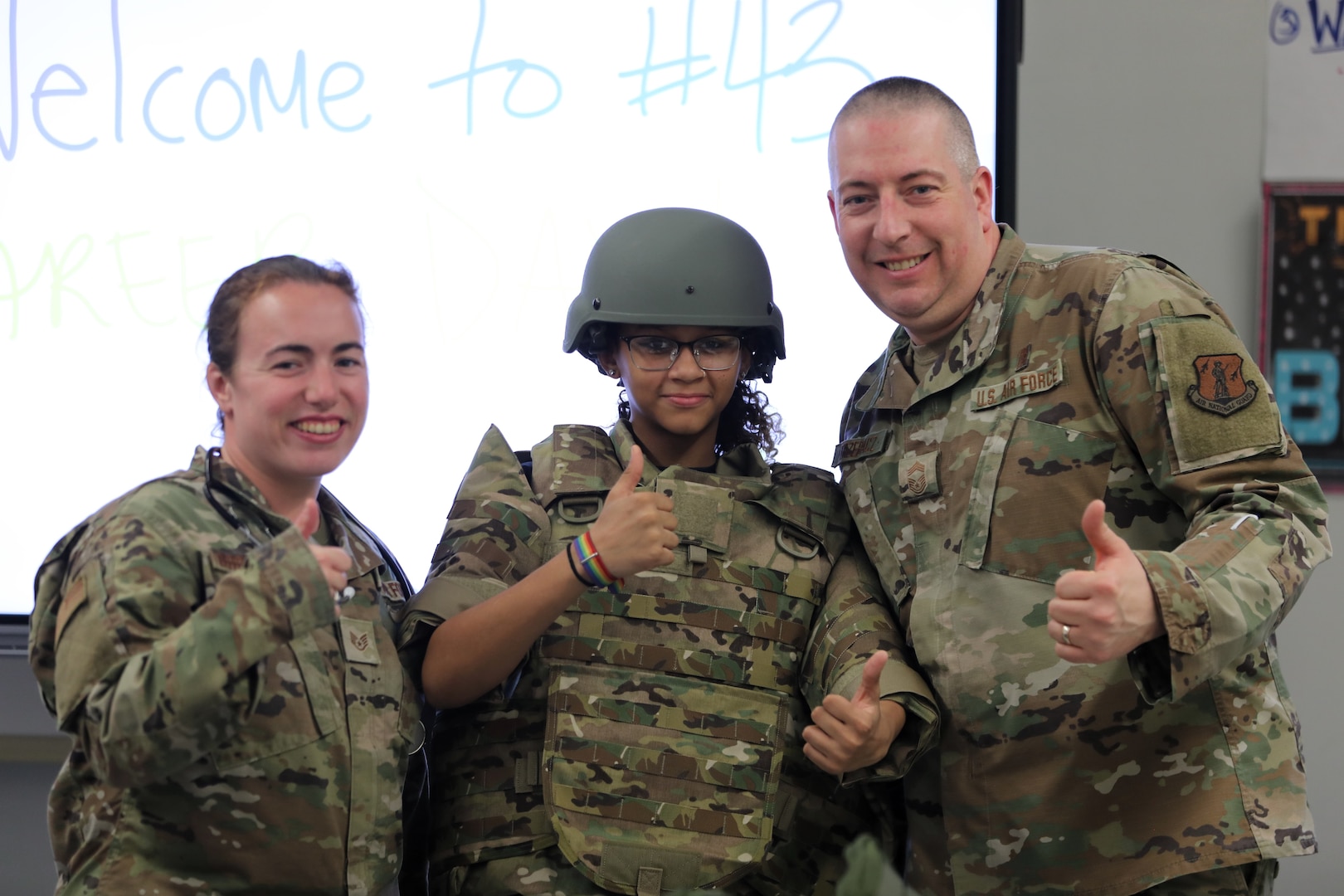 U.S. Air Force Chief Master Sgt. Donald Trzepacz and Staff Sgt. Victoria Broadwell, aerospace medical service specialists assigned to the 107th Medical Group, 107th Attack Wing, New York Air National Guard, and a 7th grade student, during career day at the Lovejoy Discover School #43 in Buffalo, N.Y., March 20, 2025. New York Army and Air National Guardsmen were invited to the school to talk to students about what it’s like to serve in the armed forces.