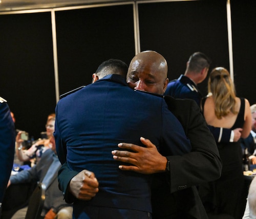 U.S. Air Force Airmen from graduating Class 25-07 present one half of their broken wings to their loved ones at Laughlin Air Force Base, Texas, March. 20, 2025.  twenty-three U.S. Air Force officers were awarded silver wings during the ceremony, symbolizing their completion of the Undergraduate Pilot Training program. (U.S. Air Force photo by Airman 1st Class Harrison Sullivan)