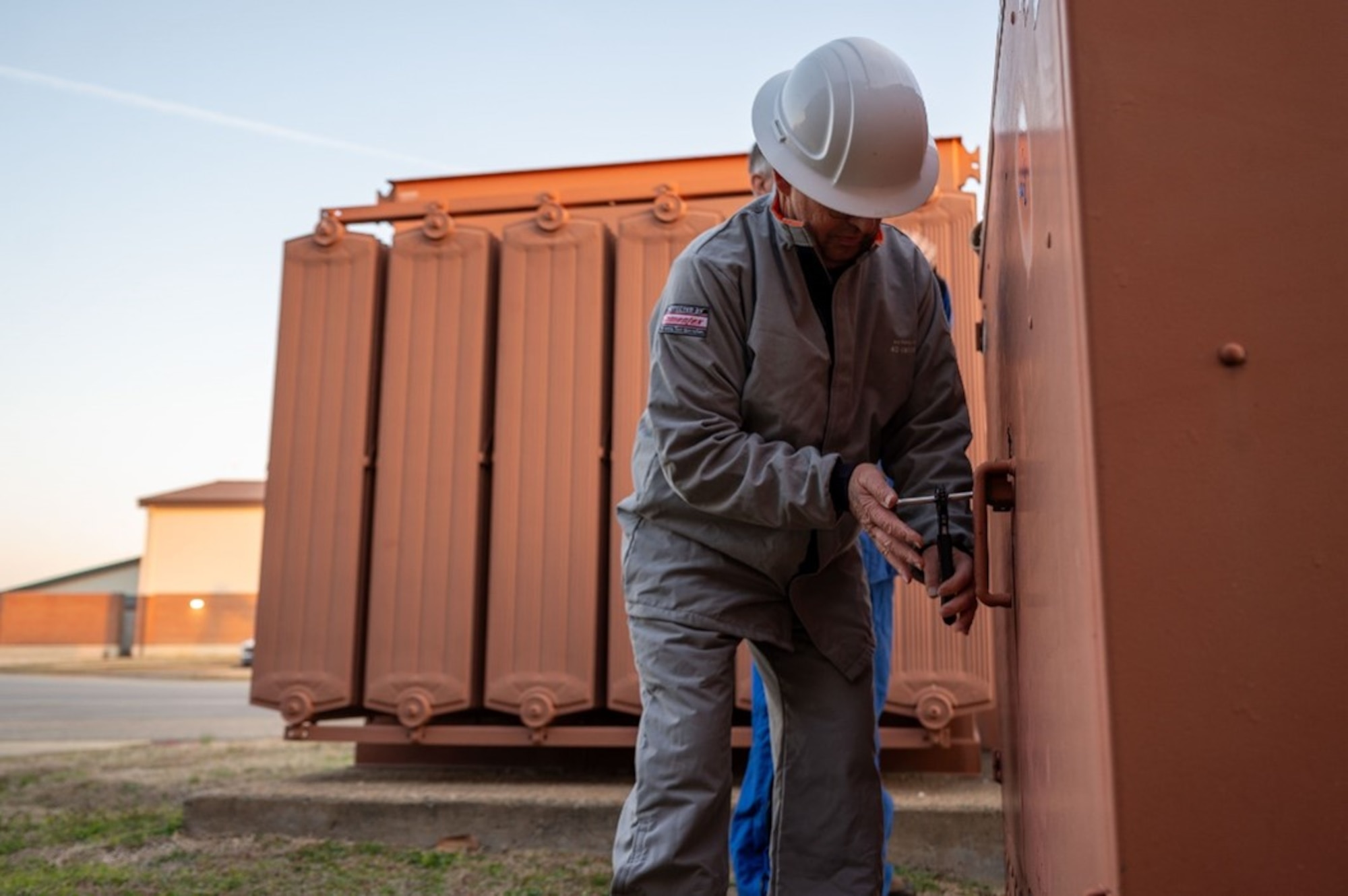 Man locks up power box. (U.S. Air Force photo by Airman 1st Class Donnell Ramsey)