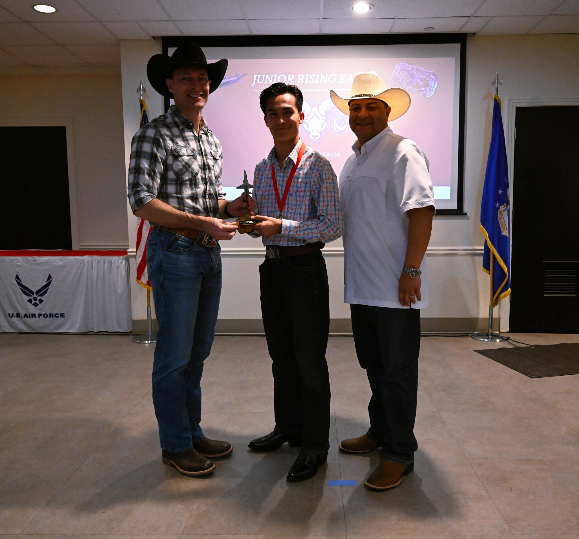U.S. Air Force Col. Tyler Ellison, 47th Flying Training Wing, commander, left, and U.S. Air Force Chief Master Sgt. Lester Largaespada, 47th Flying Training Wing, command chief, right, recognizes Alfredo Garcia as 11th grade Rising Eagle award winner. The 47th Flying Training Wing recognizes outstanding students in the San Felipe Del Rio Consolidated Independent School District Career and Technical Education program with the inaugural “Rising Eagle” award. (U.S. Air Force photo by Airman 1st Class Harrison Sullivan)