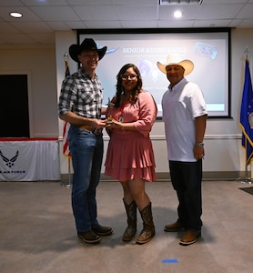 U.S. Air Force Col. Tyler Ellison, 47th Flying Training Wing, commander, left, and U.S. Air Force Chief Master Sgt. Lester Largaespada, 47th Flying Training Wing, command chief, right, recognizes Christi Colunga as 12th grade Rising Eagle award winner. The 47th Flying Training Wing recognizes outstanding students in the San Felipe Del Rio Consolidated Independent School District Career and Technical Education program with the inaugural “Rising Eagle” award. (U.S. Air Force photo by Airman 1st Class Harrison Sullivan)