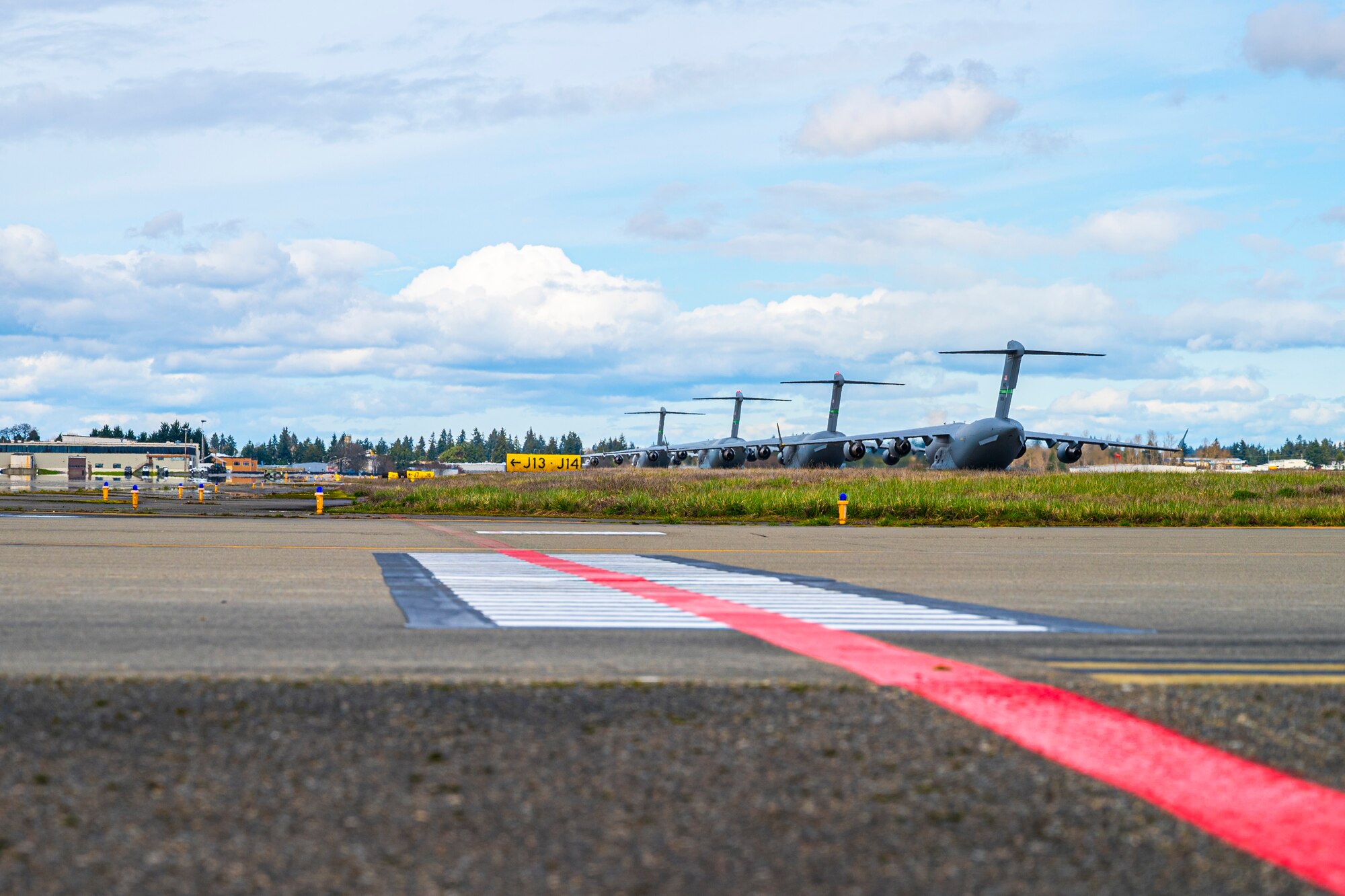 Four C-17 Globemaster IIIs are lined up before departure at Joint Base Lewis-McChord, Washington, March 18, 2025.
