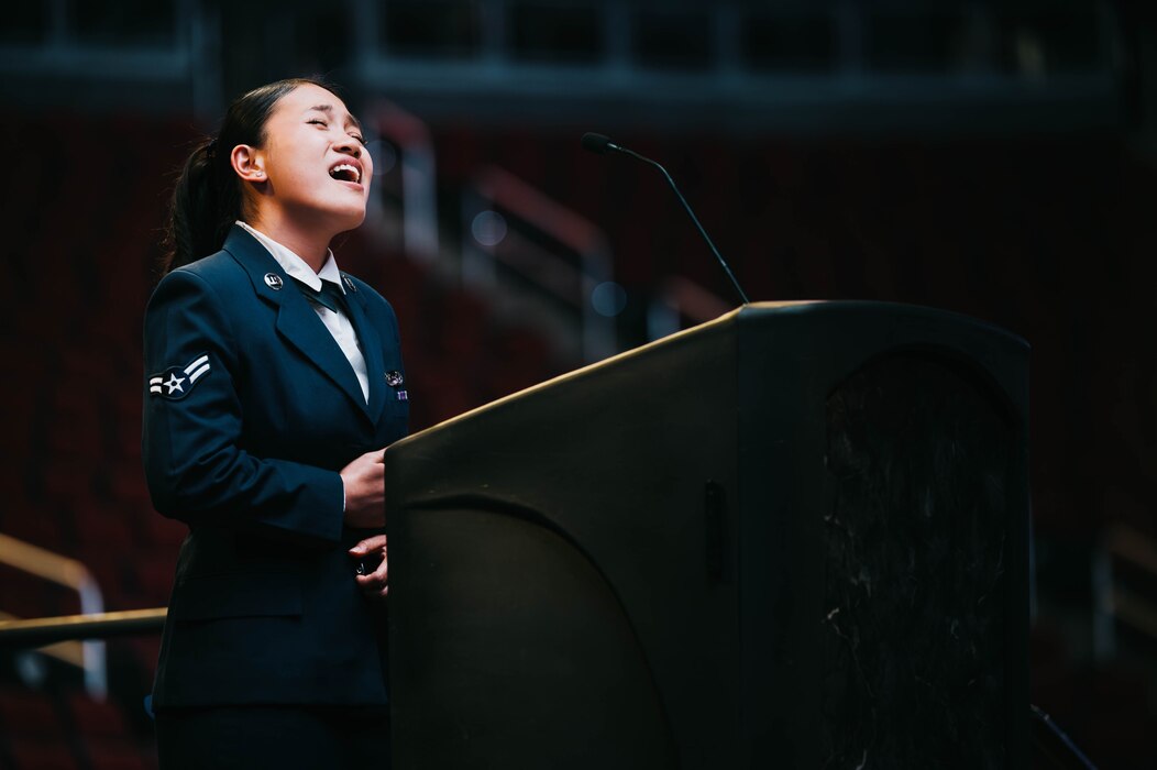 U.S. Air Force Airman 1st Class Mickaella Badilla, 56th Mission Support Group assignment counselor, sings the national anthem at the 56th Fighter Wing 2025 Dining Out.