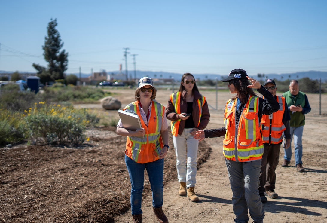 Tara Fitzgerald, EPA Pacific Southwest incident commander for EPA’s Emergency Response to the Los Angeles Wildfires, third from left, talks with Lily Schaffer, geologist with the U.S. Army Corps of Engineers Los Angeles District’s Engineering Division, left, during a walkthrough of Lario Park Staging Area March 19 in Azusa, California.