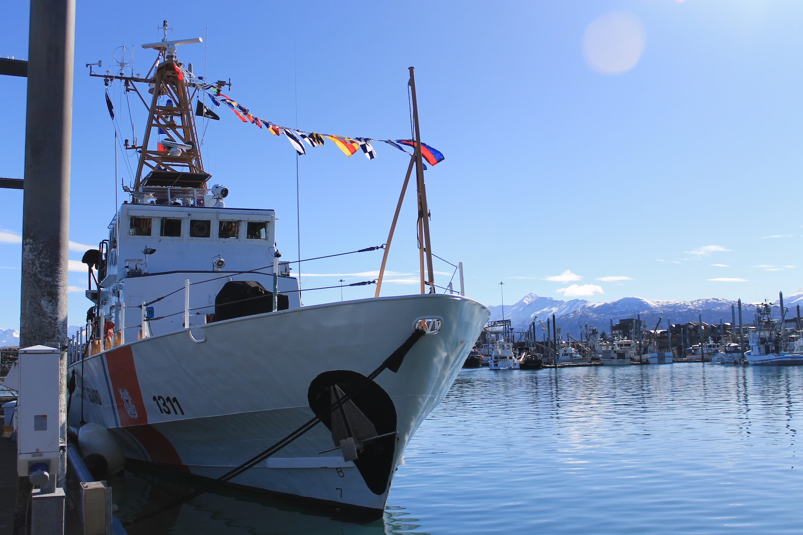 Rear Adm. Megan Dean, commander of Coast Guard District 17, and Coast Guard Cutter Naushon (WPB 1311) crewmembers presenting an award during the Naushon decommissioning ceremony in Homer, Alaska, March 21, 2025. Naushon has been stationed in Homer since 2016 and has since responded to over 50 search-and-rescue cases and completed nearly 900 law enforcement sorties. - U.S. Coast Guard photo by Seam Sydney Sharpe