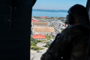 U.S. Air Force Tech. Sgt. Joseph Villano, 6th Security Forces Squadron Coastal Observation Aerial Security Team program manager surveys MacDill Air Base from a UH-60 Black Hawk assigned to the 5th Army Reserve Battalion-159th Aviation Regiment March 7, 2025.