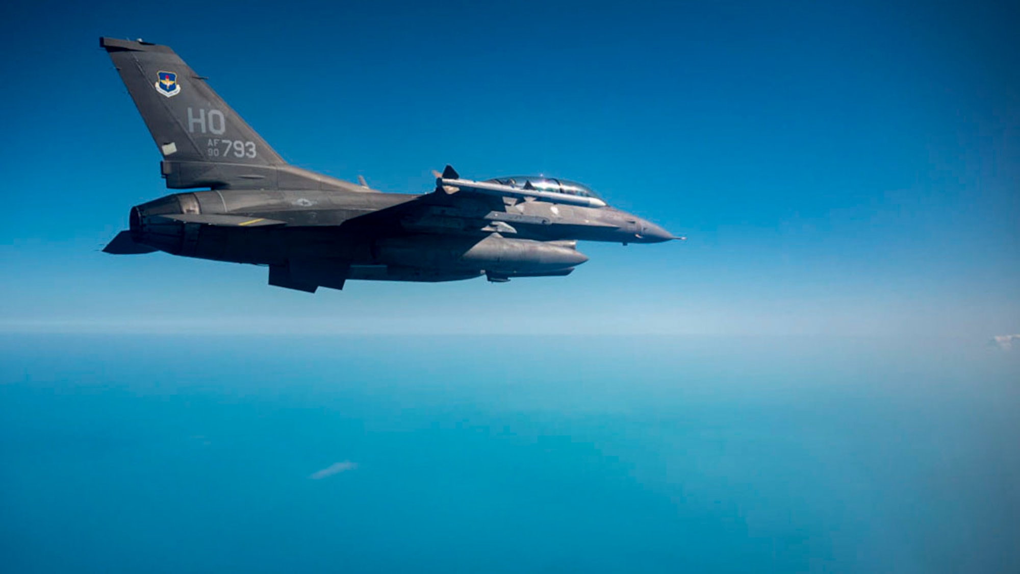 A U.S. Air Force F-16 Fighting Falcon from Holloman Air Force Base flies over Key West during a Large Force Exercise at Homestead Air Reserve Base, Florida, March 13, 2025. The LFE provided invaluable exposure to new environments and equipment, enabling Airmen to adapt quickly and efficiently, enhancing their ability to deploy, operate, and troubleshoot in dynamic and ever-changing conditions. (U.S. Air Force photo by Senior Airman Michelle Ferrari)