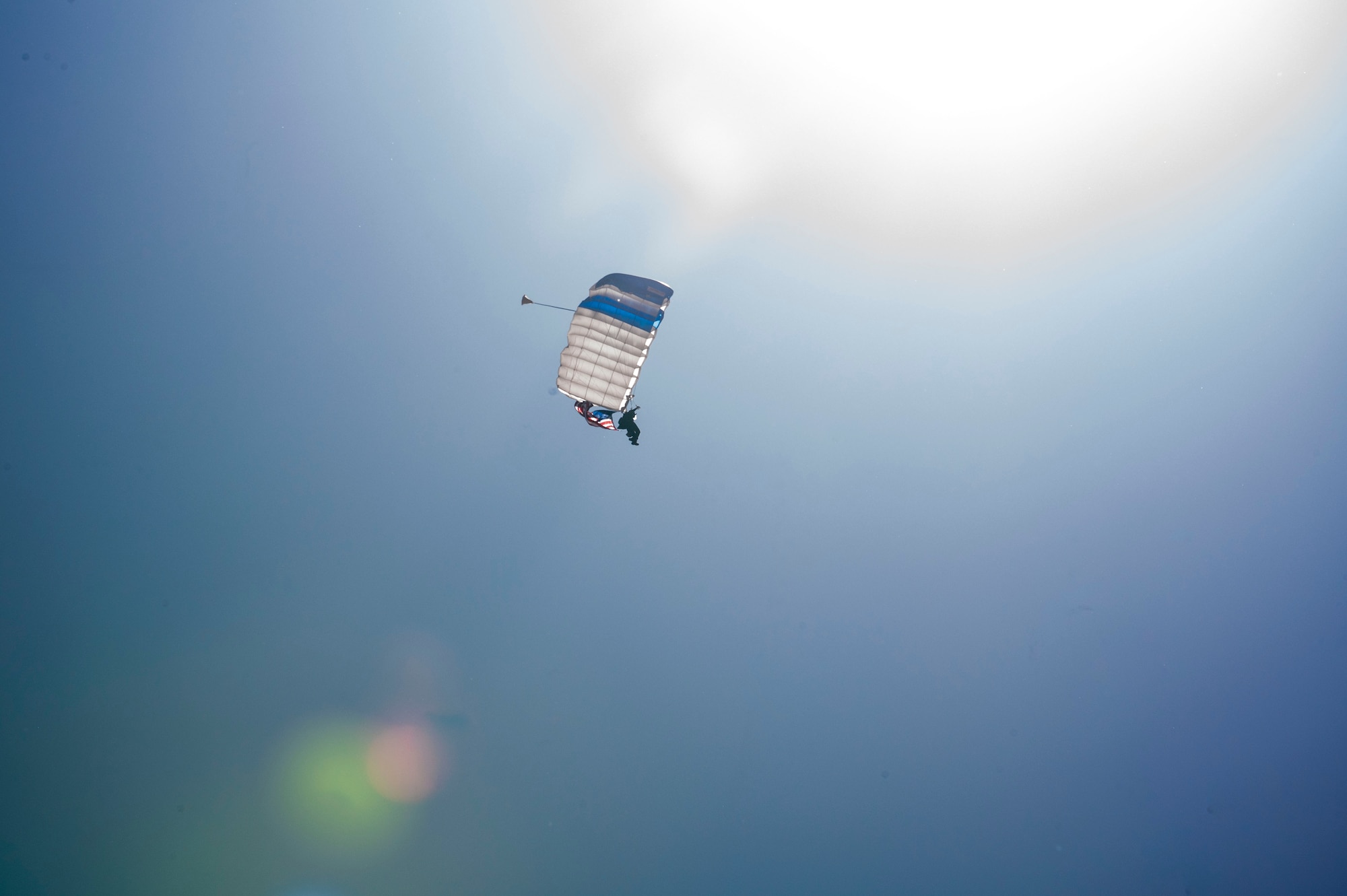 The U.S. Air Force Wings of Blue Parachute Team perform during the 2025 Thunder and Lightning Over Arizona Air Show and Open House at Davis-Monthan Air Force Base, Arizona, March 22, 2025. The Wings of Blue flew with the flags of each U.S. service branch while parachuting, paying respect to all U.S. military service members. (U.S. Air Force photo by Airman Samantha Melecio)