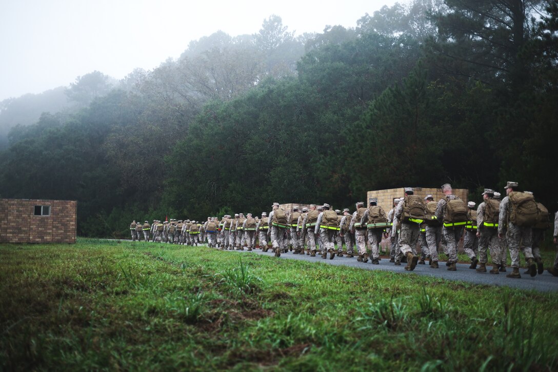 U.S. Marines with Headquarters and Headquarters Squadron, Marine Corps Air Station (MCAS) Beaufort, participate in a hike at MCAS Beaufort, South Carolina, Nov. 8, 2024. The hike was to celebrate the Marine Corps birthday, honor the history, and embody the physical and mental resilience of the Marine Corps. (U.S. Marine Corps photo by Cpl. Mason Coots)