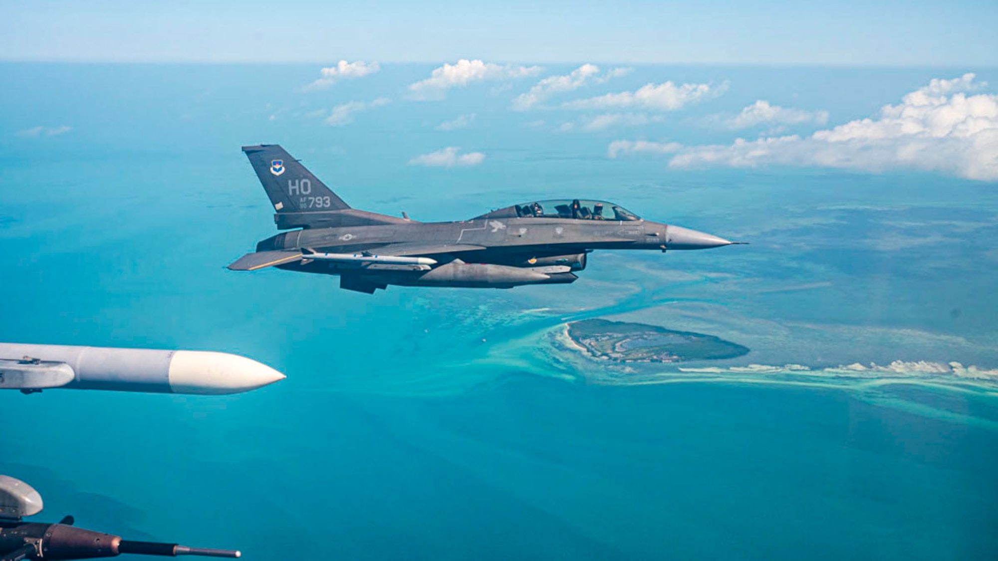 A U.S. Air Force F-16 Fighting Falcon assigned to Holloman Air Force Base flies over Key West during a Large Force Exercise at Homestead Air Reserve Base, Florida, March 13, 2025. The LFE provided invaluable exposure to new environments and equipment, enabling Airmen to adapt quickly and efficiently, enhancing their ability to deploy, operate, and troubleshoot in dynamic and ever-changing conditions. (U.S. Air Force photo by Senior Airman Michelle Ferrari)