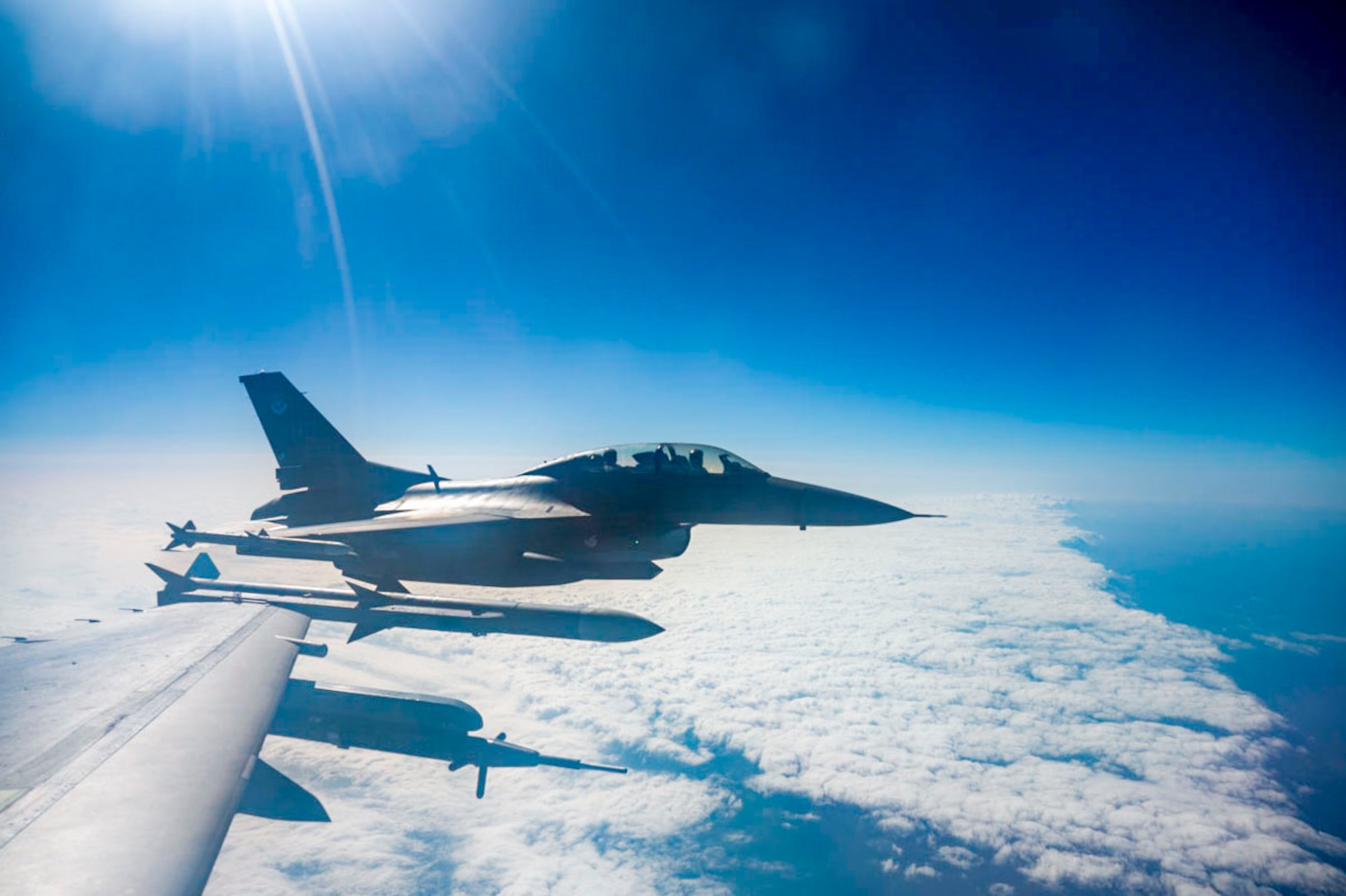 A U.S. Air Force F-16 Fighting Falcon assigned to Holloman Air Force Base flies over Key West during a Large Force Exercise at Homestead Air Reserve Base, Florida, March 13, 2025. Conducting an LFE allows personnel to focus on enhancing readiness, adaptability, and cross-unit collaboration among Airmen, pilots, and maintenance teams. (U.S. Air Force photo by Senior Airman Michelle Ferrari)
