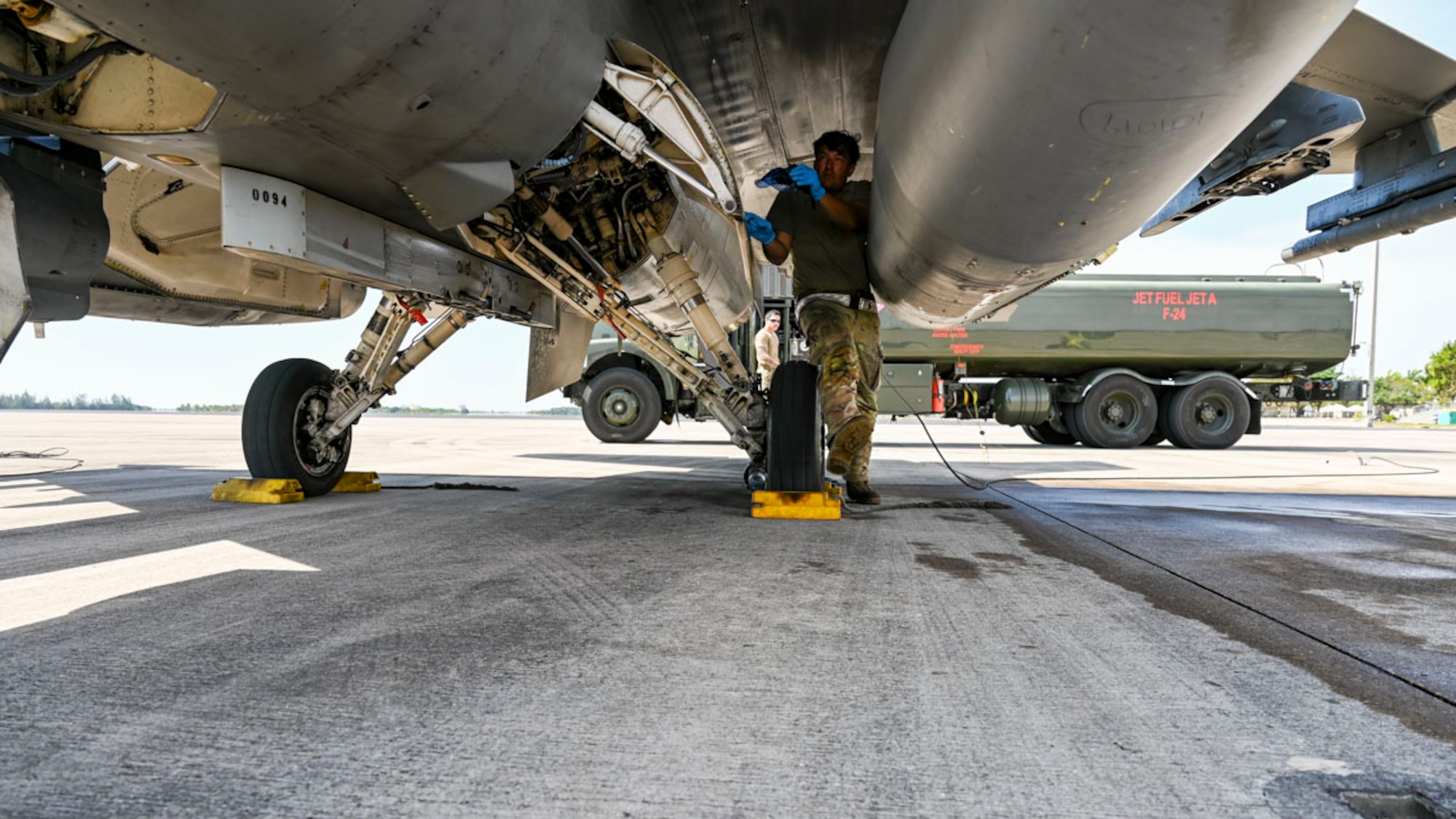 U.S. Air Force Senior Airman Allan Rodriguez, 49th Logistics Readiness Squadron fuels distribution operator, back, and U.S. Air Force Senior Airman Eric Segura, 849th Aircraft Maintenance Unit crew chief, performs end of runway procedures at Homestead Air Reserve Base, Florida, March 10, 2025. The LFE provided invaluable exposure to new environments and equipment, enabling Airmen to adapt quickly and efficiently, enhancing their ability to deploy, operate, and troubleshoot in dynamic and ever-changing conditions. (U.S. Air Force photo by Senior Airman Michelle Ferrari)