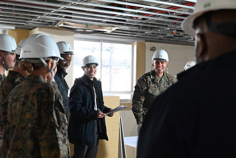 SMMC (right) stands next to others at a construction site visit.