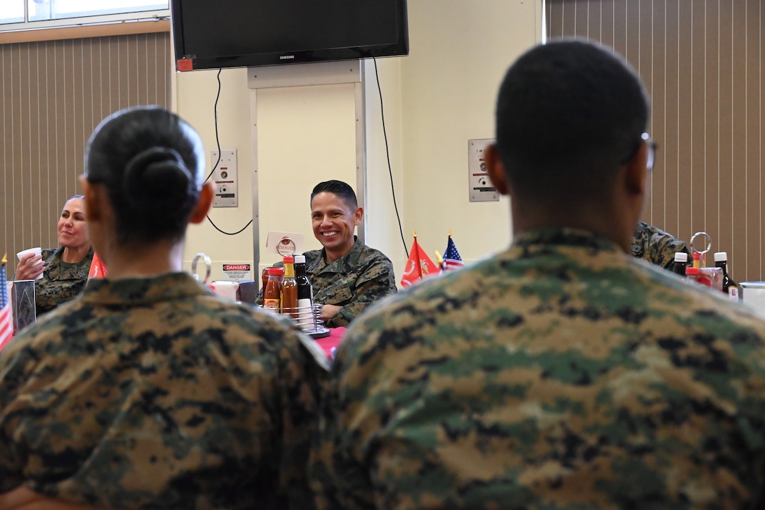 (Left to right) U.S. Marine Corps Sgt. Maj. Joy Kitashima, sergeant major of III Marine Expeditionary Force and Sgt. Maj. Carlos A. Ruiz, sergeant major of the Marine Corps, listen to a Marine during lunch. (U.S. Marine Corps photo by Song Jordan)