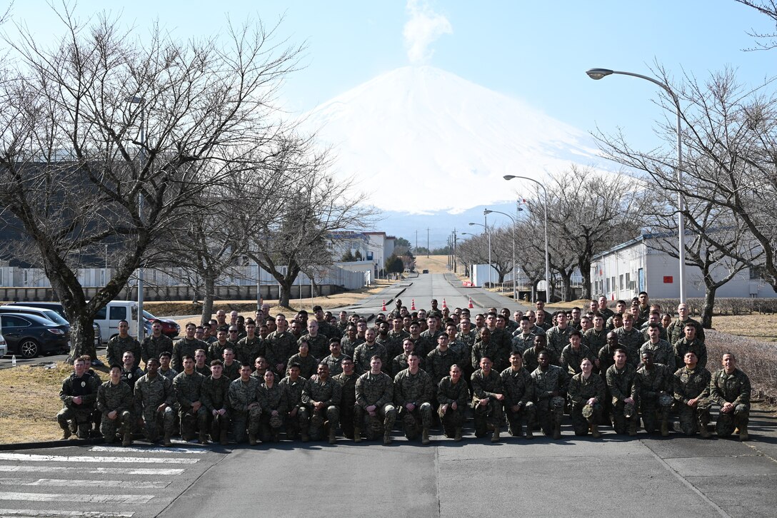 U.S. Marine Corps Sgt. Maj. Carlos A. Ruiz, the sergeant major of the Marine Corps, visited Marines, sailors, and staff at Combined Arms Training Center, Camp Fuji, Japan, March 21, 2025. It is his fourth visit to the INDOPACOM as the SMMC. Ruiz agreed to take a photo with Marines and sailors at the end of his visit. (U.S. Marine Corps photo by Song Jordan)