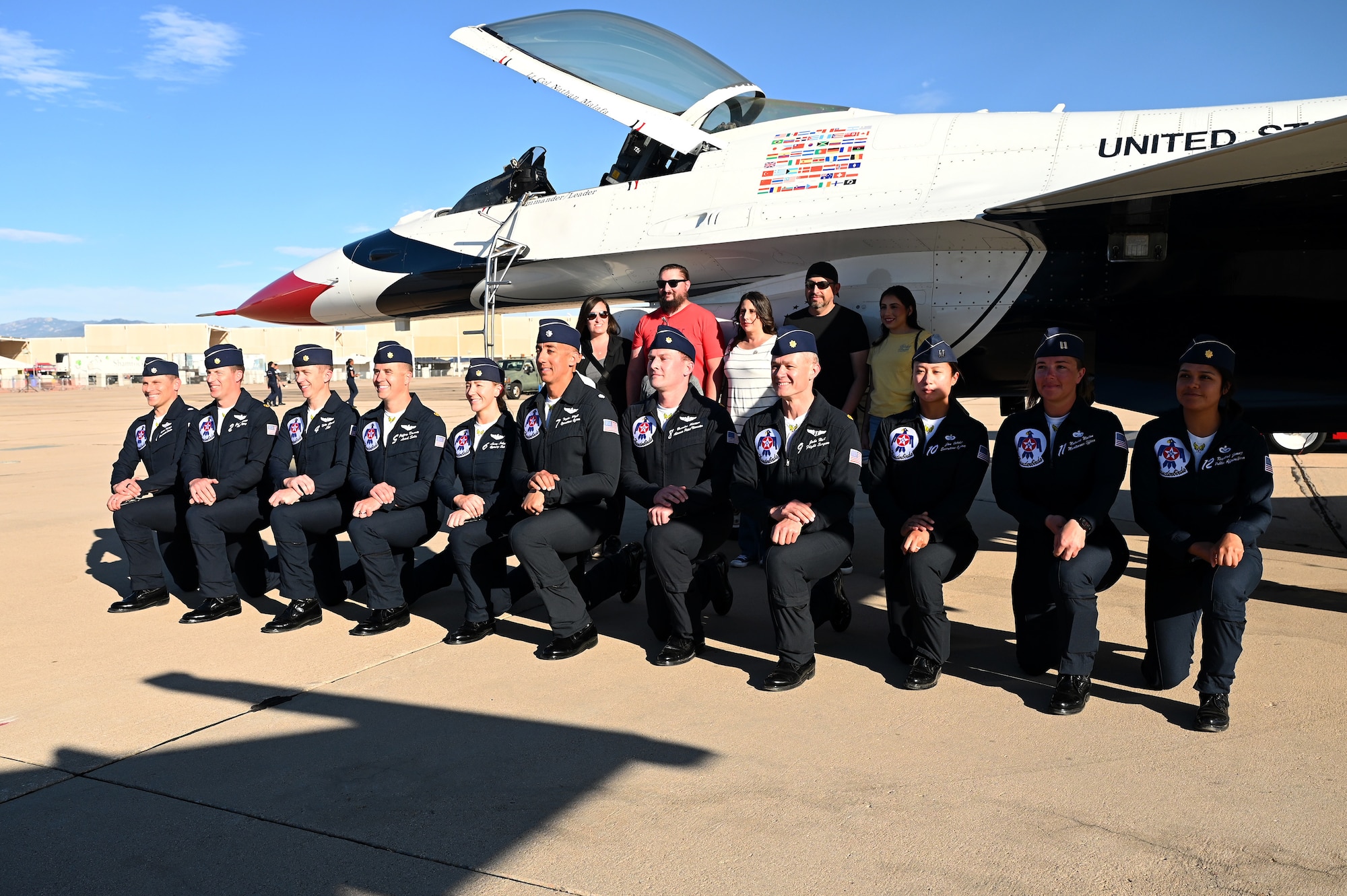 The United States Air Force Air Demonstration Squadron "Thunderbirds” pose with educators during the Thunder and Lightning Over Arizona Air Show at Davis-Monthan Air Force Base, Arizona, March 23, 2025. DM’s air show was a biannual event which gave people a chance to see U.S. Air Force airpower, like the Thunderbirds, in action. (U.S. Air Force photo by Senior Airman Andrew Garavito)