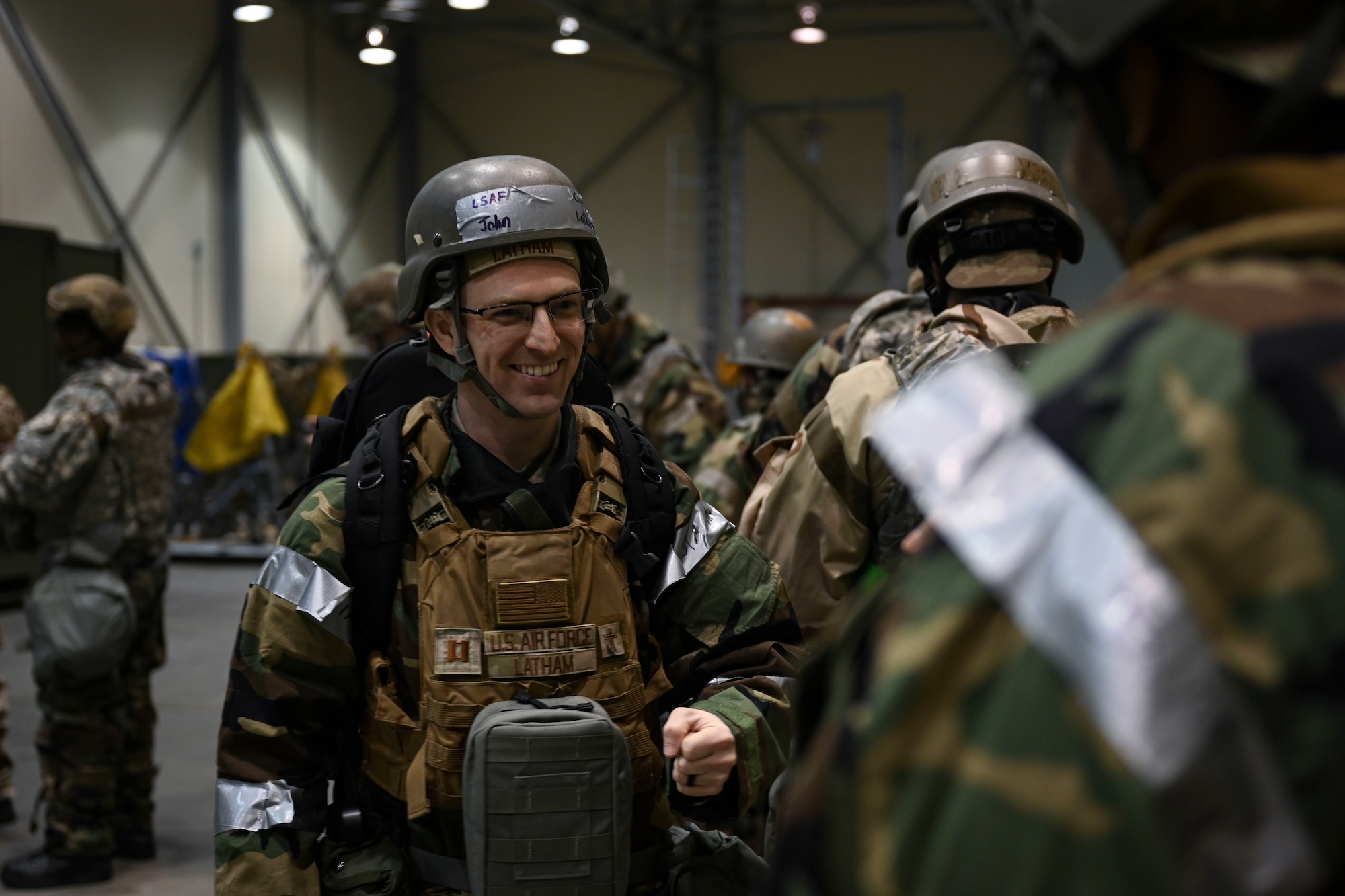 U.S. Air Force Capt. John Latham, 8th Fighter Wing chaplain, provides an early morning boost to Airmen in the weapons distribution line during Freedom Shield 25 at Gwangju Air Base, Republic of Korea.