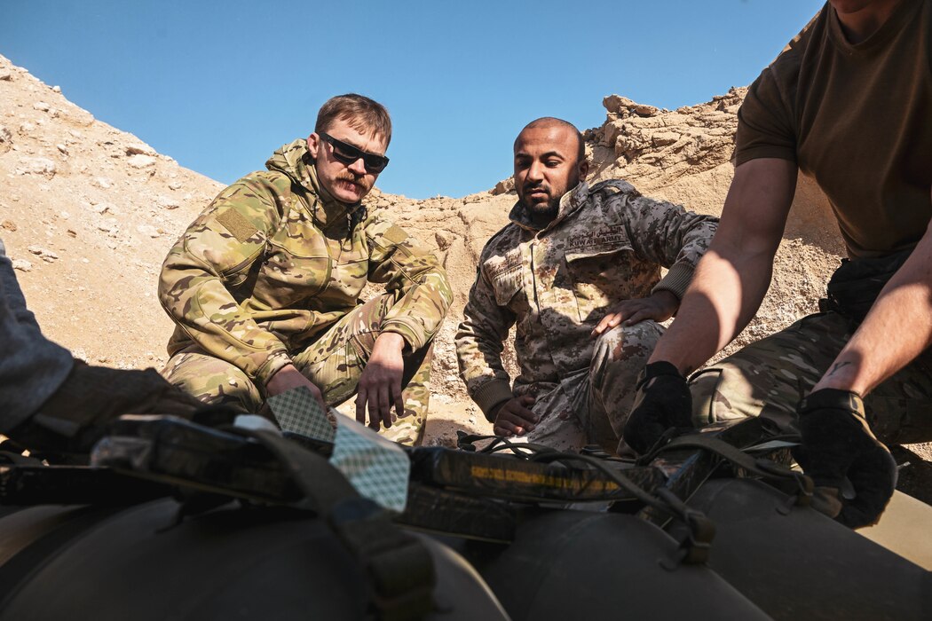A U.S. Air Force member works alongside host nation service members.