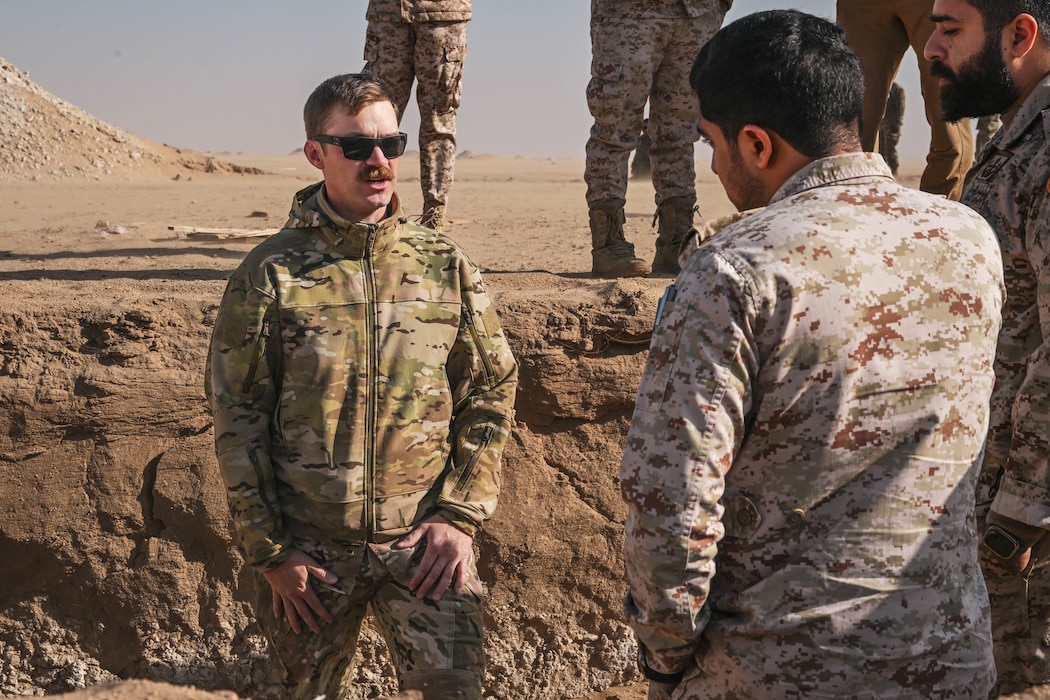 A U.S. Air Force members speaks to host nation service members.