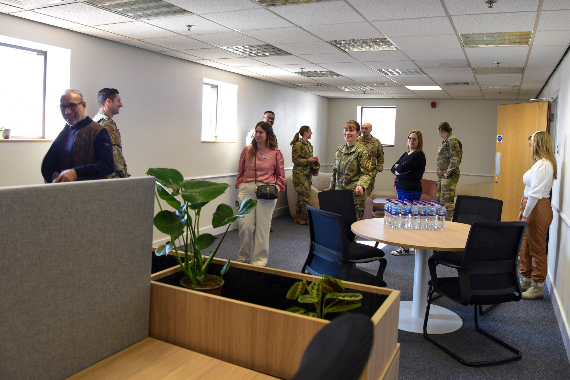 Leaders, key support liaisons, and community members of Team Mildenhall walk around the newly opened KSL Hub at RAF Mildenhall, England, March 19, 2025.