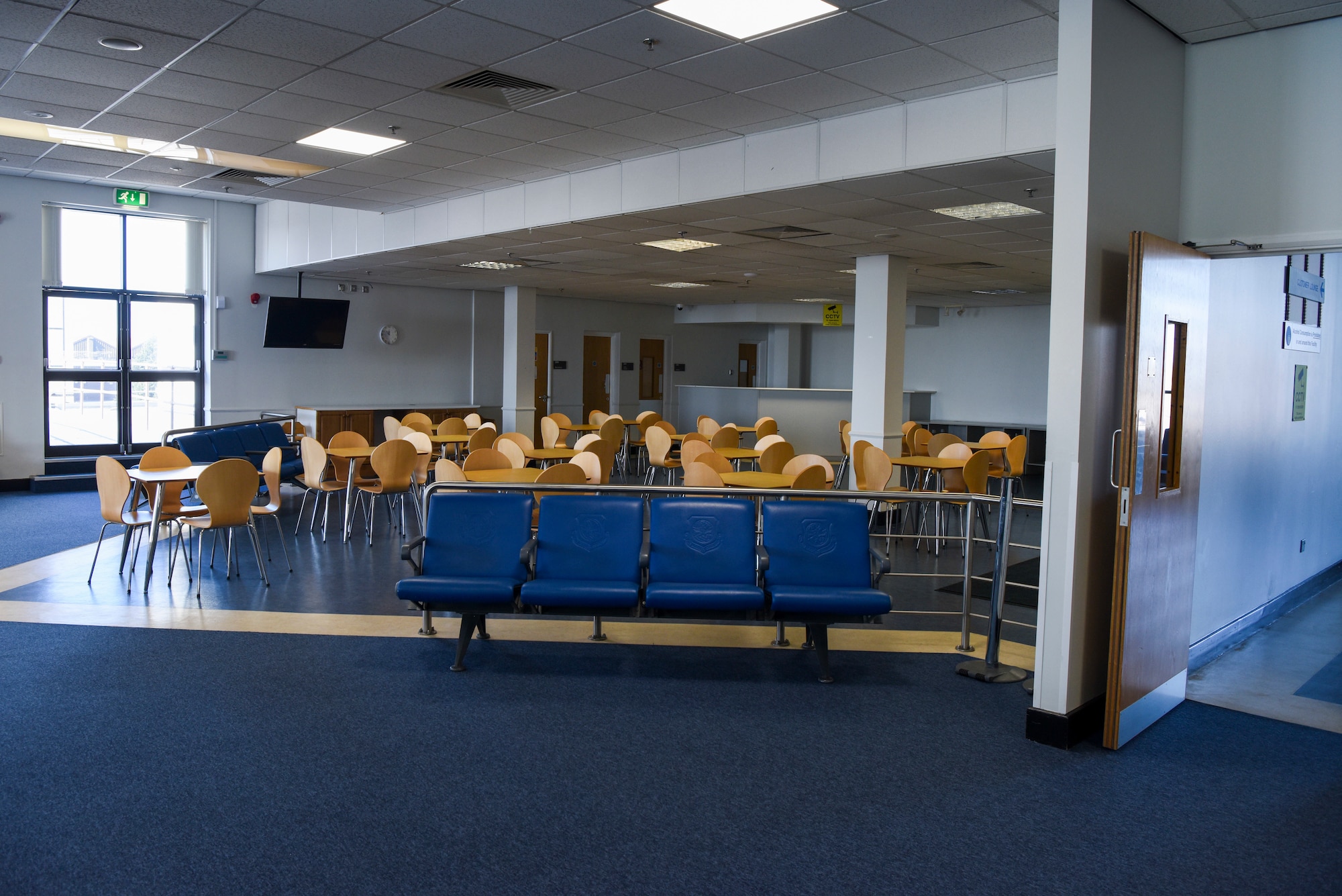 Tables and chairs sit in the customer waiting area outside of the Key Support Liaison Hub in the Passenger Terminal at RAF Mildenhall, England, March 19, 2025.
