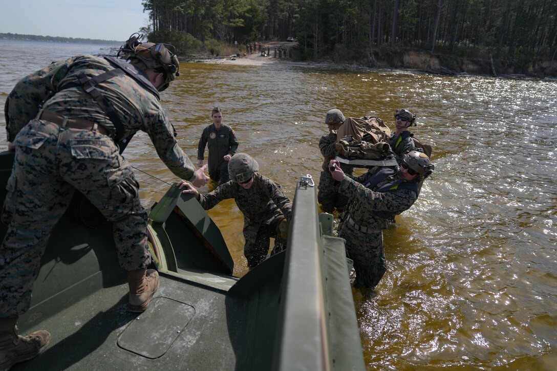 U.S. Marine Corps Sgt. Daymion Noisewater, an engineer equipment mechanic with Combat Logistics Battalion 8, Combat Logistics Regiment 2, 2nd Marine Logistics Group, assists Marines and Sailors onto a Riverine Assault Support System for a resupply run as part of Certification Exercise 25.1 on Marine Corps Base Camp Lejeune, March 20, 2025. Noisewater is a native of Oklahoma. This iteration was the largest CERTEX attempted in 2nd Medical Battalion history, validating their ability to generate combat ready medical forces in support of II Marine Expeditionary Force. (U.S. Marine Corps photo by Lance Cpl. Franco Lewis)