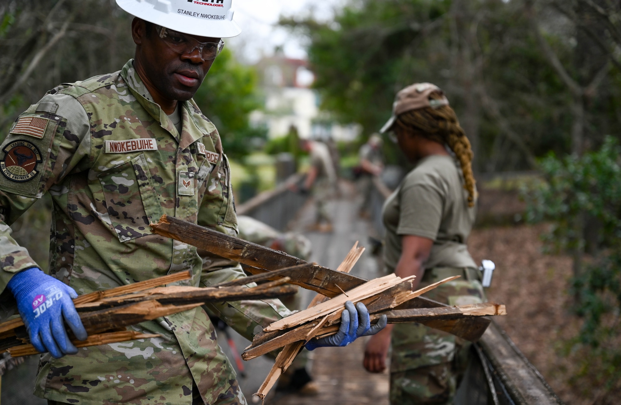 people repair a bridge