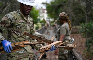 people repair a bridge