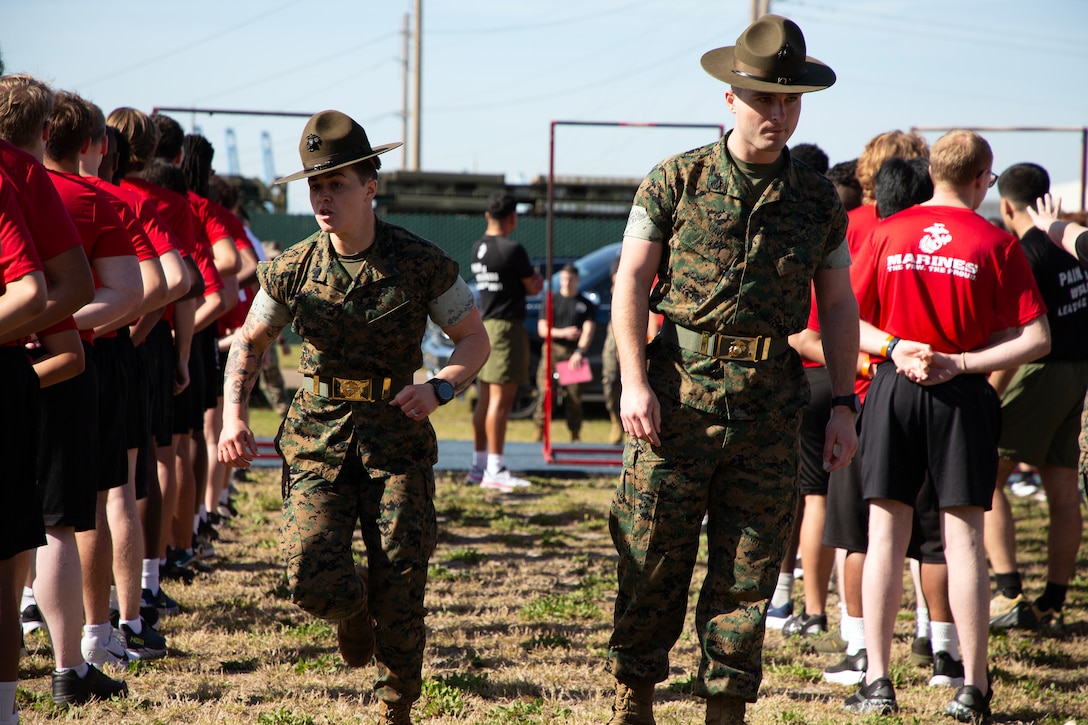 Sgt. Saraysophonh Thach and Staff Sgt. Gavin Cave, drill instructors from Marine Corps Recruit Depot Parris Island, prepares individuals scheduled for boot camp during a Marine Corps Recruiting Station Jacksonville pool function March 22 at Marine Corps Support Facility Blount Island in Jacksonville, Florida. Roughly 275 young men and women from across Florida and Georgia participated in the annual event, designed to assess the physical and mental readiness of future recruits before they ship to boot camp.