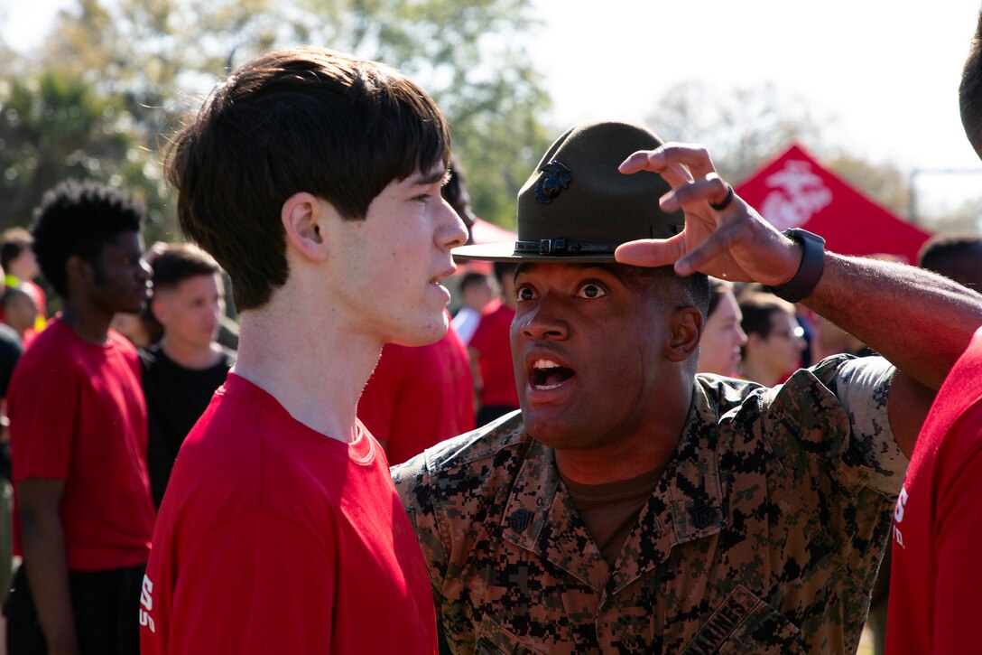 Staff Sgt. Arkeevin Lewis, drill instructor from Marine Corps Recruit Depot Parris Island, prepares individuals scheduled for boot camp during a Marine Corps Recruiting Station Jacksonville pool function March 22 at Marine Corps Support Facility Blount Island in Jacksonville, Florida. Roughly 275 young men and women from across Florida and Georgia participated in the annual event, designed to assess the physical and mental readiness of future recruits before they ship to boot camp.