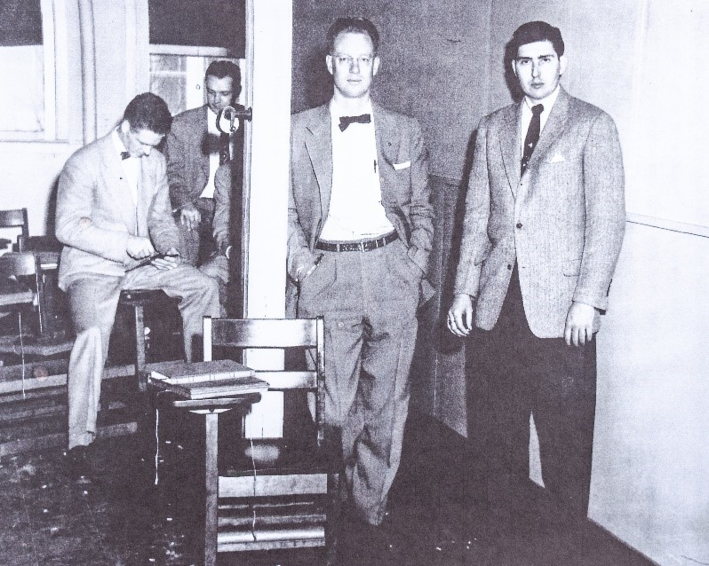 Roy, center, leans against a post with other new ONI/NIS agents during Basic Agent Training in Washington, D.C.  in 1954.