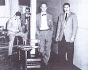 Roy, center, leans against a post with other new ONI/NIS agents during Basic Agent Training in Washington, D.C.  in 1954.