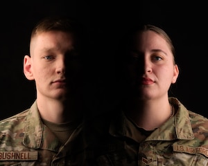 U.S. Air Force Senior Airman Peyton Bushnell, 52nd Maintenance Squadron aerospace propulsion technician, left, and Senior Airman Audrey Harris, 52nd Medical Operations Squadron aerospace medical technician, right, are portrayed in a dramatic light at Spangdahlem Air Base, Germany, March 17, 2025. While off duty, Bushnell and Harris rescued a man from a vehicle that had driven off an embankment, exemplifying the Air Force core value of Service Before Self. (U.S. Air Force photo illustration by Airman 1st Class Demi M. Ebert)