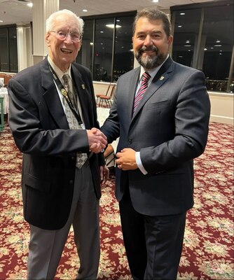 Director Omar Lopez poses for a photo with Roy Mosteller at the 2023 NCIS Association’s National Conference in Nashville.