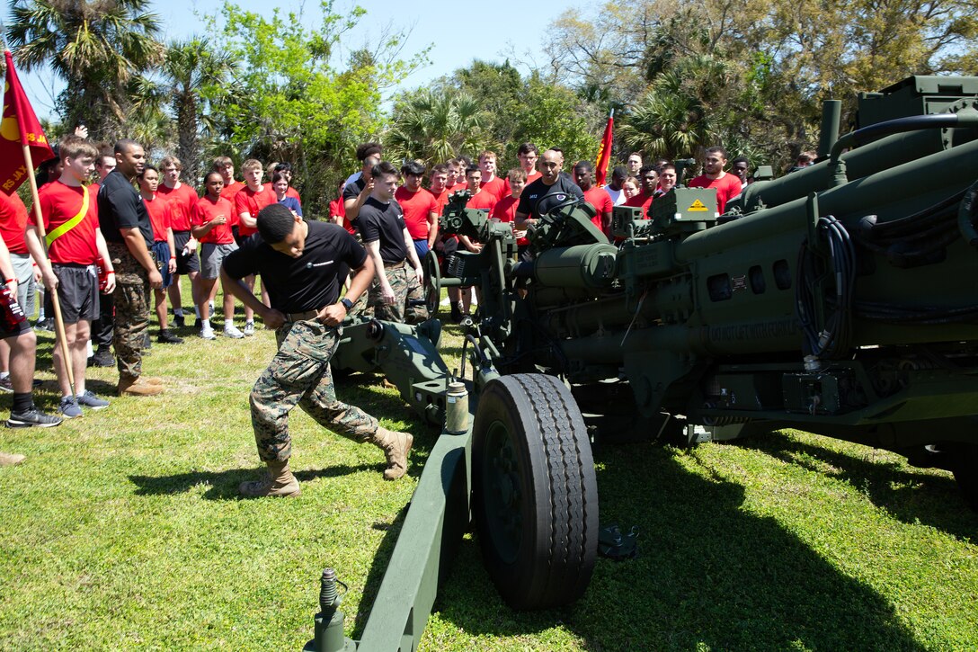 Marines explain M777 howitzer operations to individuals scheduled for boot camp during a Marine Corps Recruiting Station Jacksonville pool function March 22 at Marine Corps Support Facility Blount Island in Jacksonville, Florida. Roughly 275 young men and women from across Florida and Georgia participated in the annual event, designed to assess the physical and mental readiness of future recruits before they ship to boot camp.