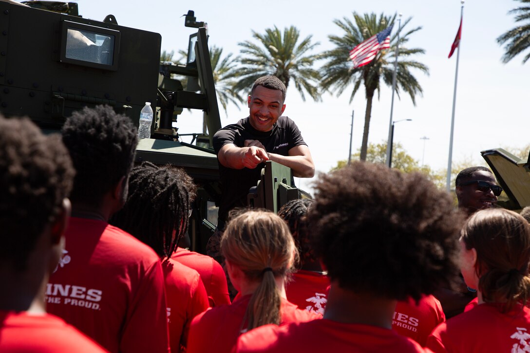 Marines explain Joint Light Tactical Vehicle capabilities to individuals scheduled for boot camp during a Marine Corps Recruiting Station Jacksonville pool function March 22 at Marine Corps Support Facility Blount Island in Jacksonville, Florida. Roughly 275 young men and women from across Florida and Georgia participated in the annual event, designed to assess the physical and mental readiness of future recruits before they ship to boot camp.