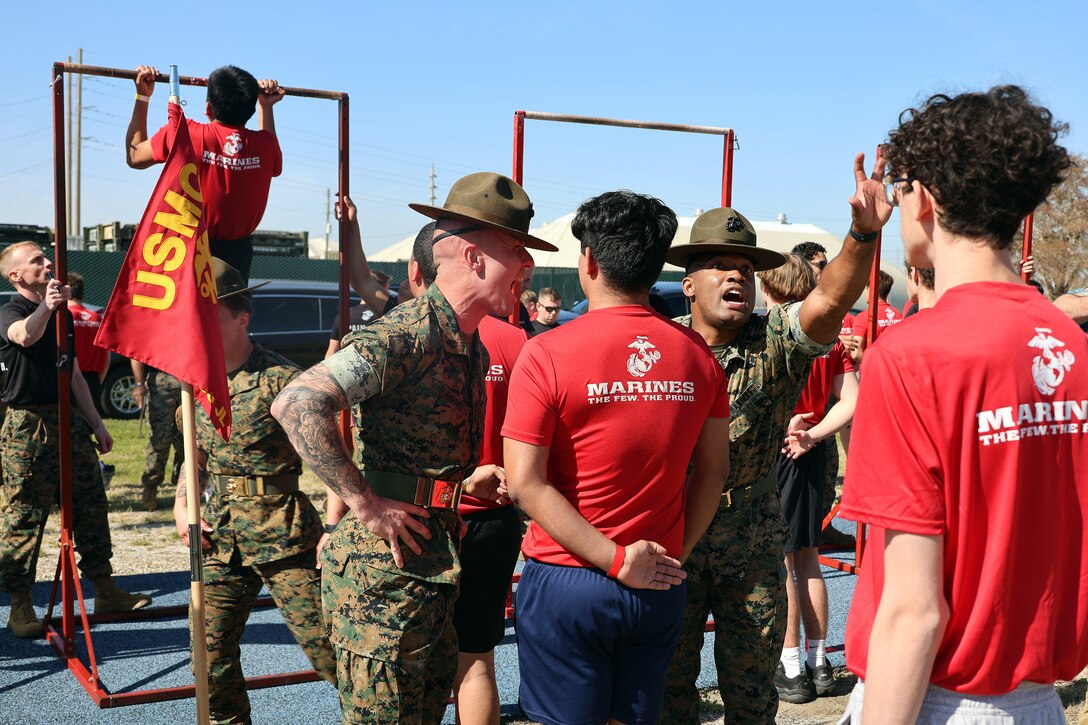 Sgt. Devin Eovaldi and Staff Sgt. Arkeevin Lewis, drill instructors from Marine Corps Recruit Depot Parris Island, prepare individuals scheduled for boot camp during a Marine Corps Recruiting Station Jacksonville pool function March 22 at Marine Corps Support Facility Blount Island in Jacksonville, Florida. Roughly 275 young men and women from across Florida and Georgia participated in the annual event, designed to assess the physical and mental readiness of future recruits before they ship to boot camp.