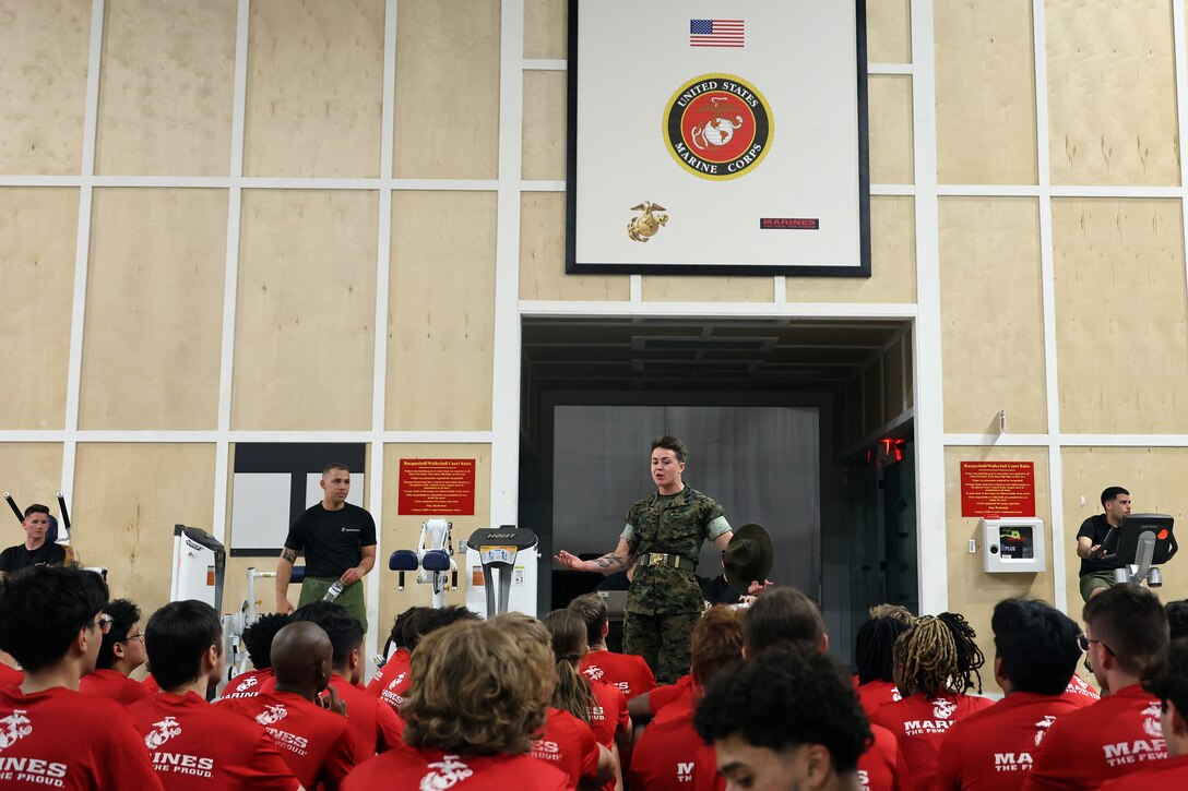 Sgt. Saraysophonh Thach, drill instructor from Marine Corps Recruit Depot Parris Island, answers questions from individuals scheduled for boot camp during a Marine Corps Recruiting Station Jacksonville pool function March 22 at Marine Corps Support Facility Blount Island in Jacksonville, Florida. Roughly 275 young men and women from across Florida and Georgia participated in the annual event, designed to assess the physical and mental readiness of future recruits before they ship to boot camp.