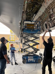 Three engineers scanning a B1 aircraft