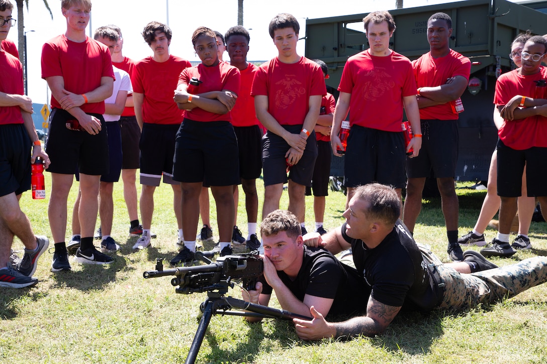 Marines explain M240 machine gun crew maneuvers to individuals scheduled for boot camp during a Marine Corps Recruiting Station Jacksonville pool function March 22 at Marine Corps Support Facility Blount Island in Jacksonville, Florida. Roughly 275 young men and women from across Florida and Georgia participated in the annual event, designed to assess the physical and mental readiness of future recruits before they ship to boot camp.