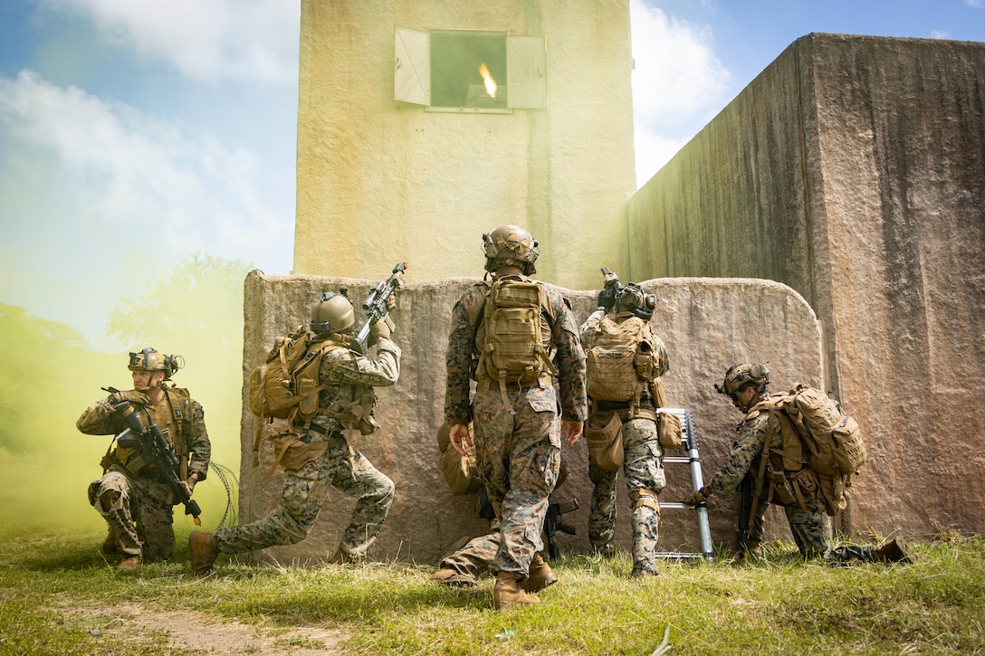 U.S. Marine Corps students with School of Infantry-West, Advanced Infantry Training Battalion, Detachment Hawaii, carry out close quarters combat operations during the Advanced Infantry Marine Course at Bellows Air Force Station, Hawaii, March 12, 2025. Multi-day training was conducted as part of the AIMC, a course designed to test and progress military occupational specialty skills within the infantry and certify Marines to be squad leaders. (U.S. Marine Corps photo by Cpl. Matthew Benfield)