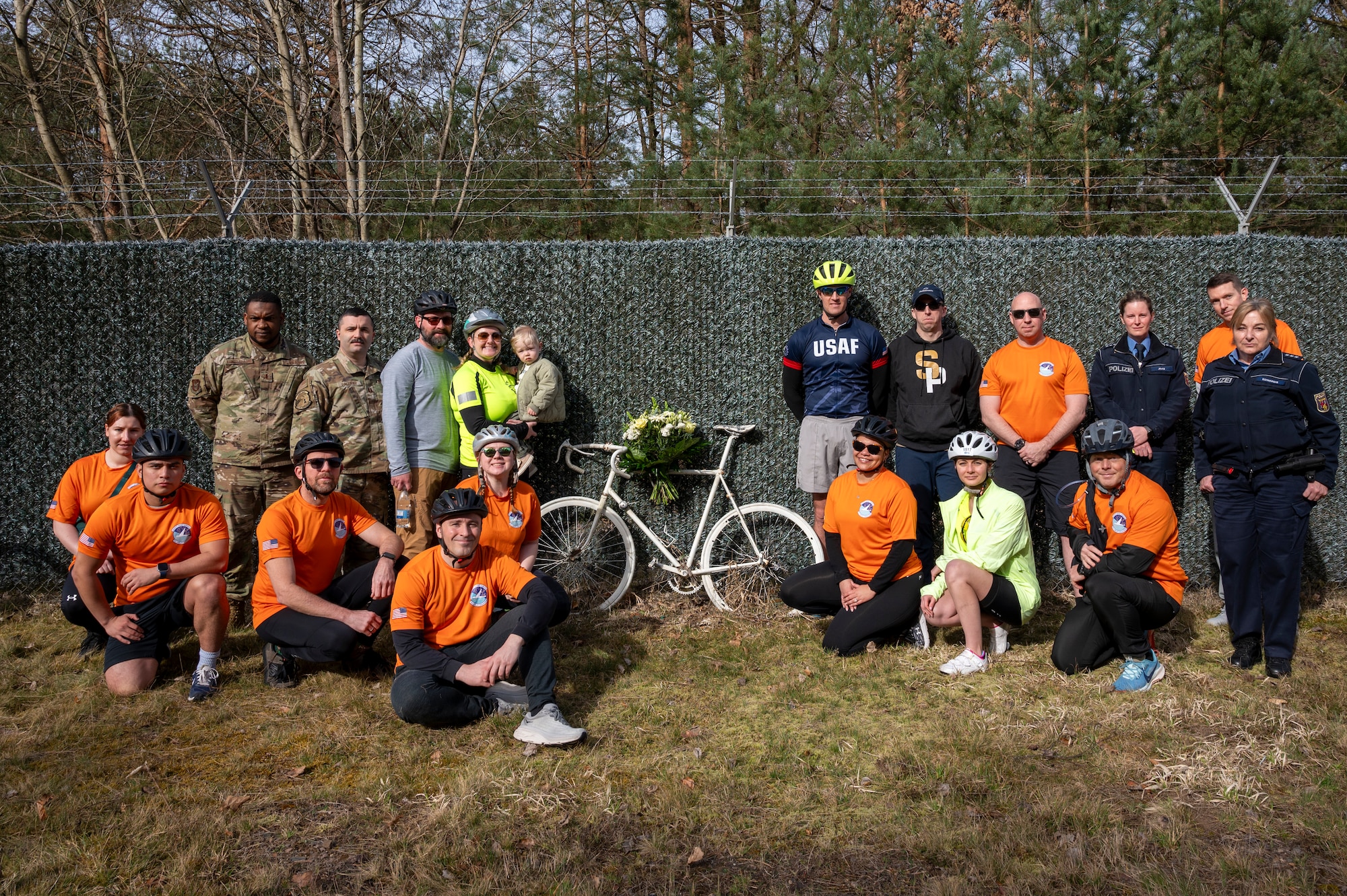 U.S. Air Force chaplains, 76th Airlift Squadron members and German Polizei members pose for a group photo at Staff Sgt. Grant Davis’ roadside memorial near Ramstein Air Base, Germany, March 21, 2025.