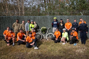 U.S. Air Force chaplains, 76th Airlift Squadron members and German Polizei members pose for a group photo at Staff Sgt. Grant Davis’ roadside memorial near Ramstein Air Base, Germany, March 21, 2025.